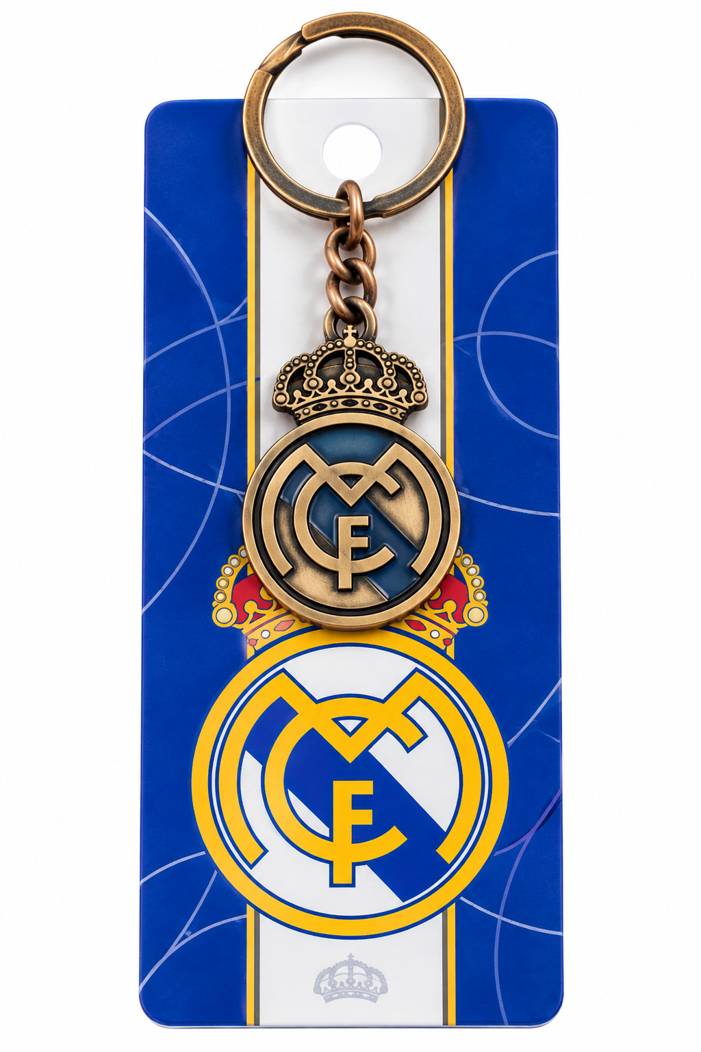 Llavero del Real Madrid con el escudo y la corona en metal color cobre, en su tarjeta azul y blanca