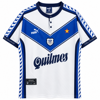 Frente de la camiseta retro blanca de Vélez Sarsfield con la V azul al pecho, Puma, Quilmes y una estrella roja