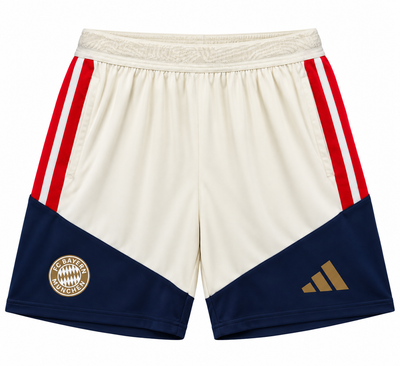 Pantaloneta crema del Bayern Múnich con paneles azul marino abajo, rayas rojas a los lados y escudo dorado