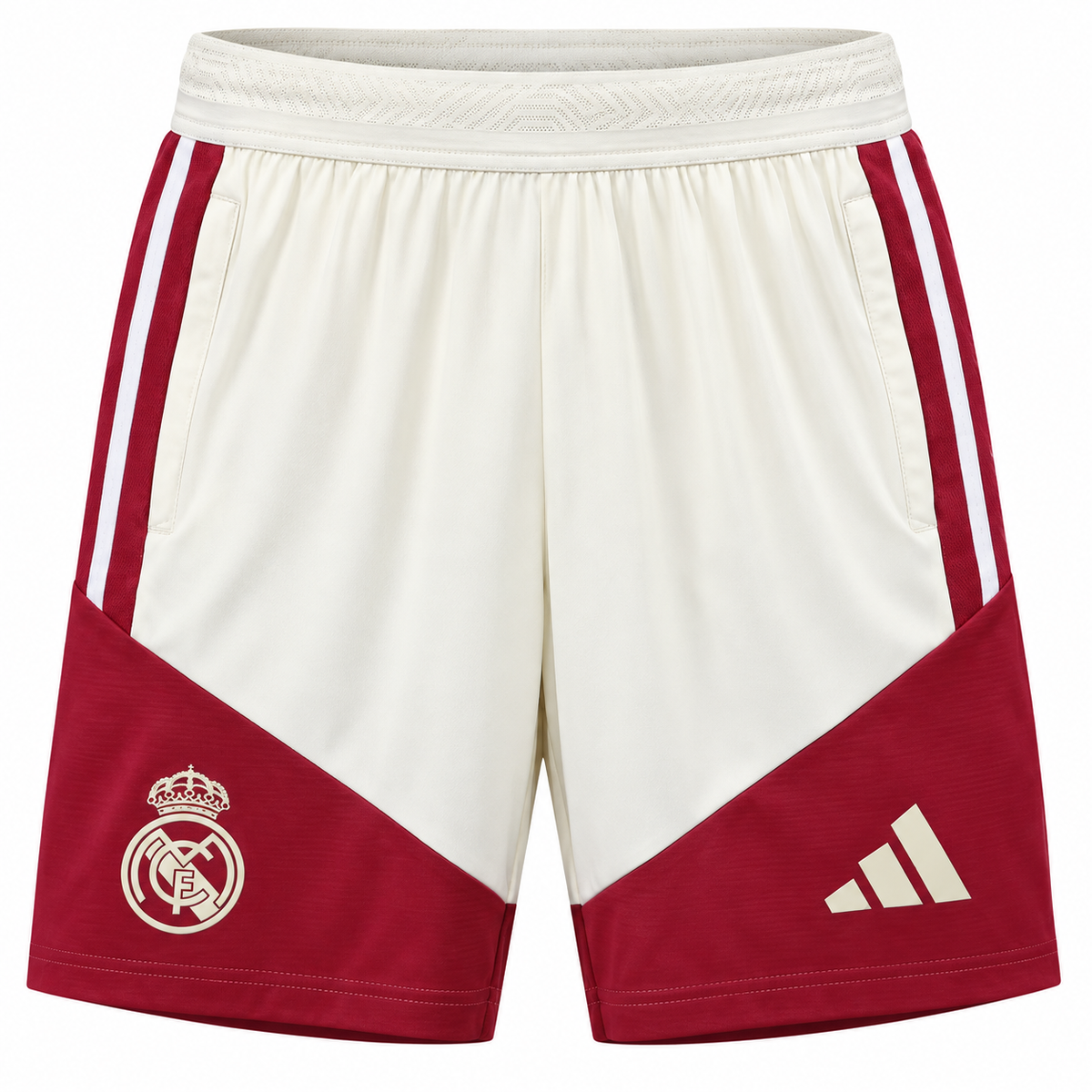 Pantaloneta crema del Real Madrid con paneles vinotinto abajo, tres rayas a los lados, escudo y logo de Adidas