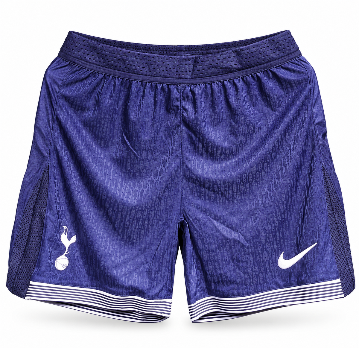 Pantaloneta azul índigo del Tottenham con rayas blancas en el borde, escudo y el logo de Nike
