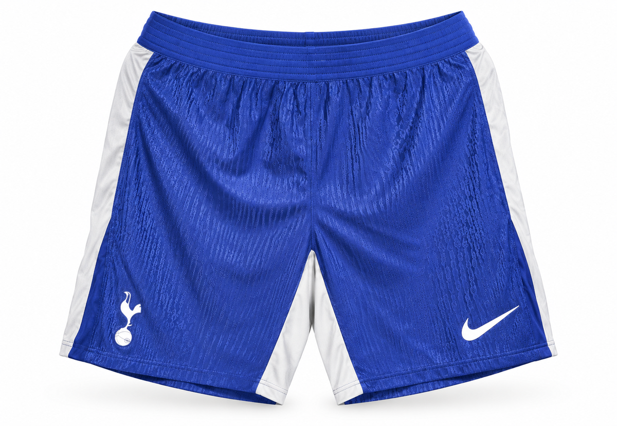 Calção azul do Tottenham com painéis brancos nas laterais, escudo e o logo da Nike